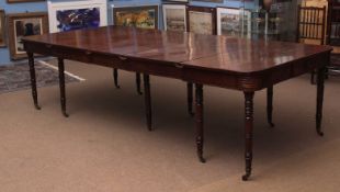 Regency period mahogany extending dining table with moulded frieze and raised on ten ring turned