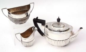 Late Victorian presentation engraved three piece tea set, each of half fluted oval form and