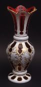 Decorative overlaid cranberry glass vase with everted rim overlaid in white and with further neo-