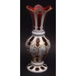 Decorative overlaid cranberry glass vase with everted rim overlaid in white and with further neo-