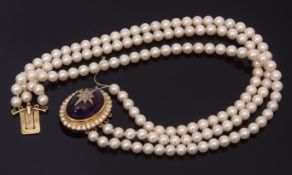 Three row cultured pearl choker necklace, the uniform beads 6mm set to a large cabochon amethyst