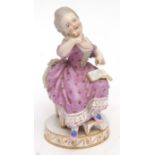 19th century Meissen model of a young girl seated reading a book, impressed numerals and crossed