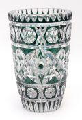 Heavy lead crystal glass vase, heavily faceted and highlighted in iridescent green throughout, on