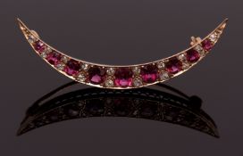 Ruby and diamond crescent brooch, having nine graduated oval and circular cut rubies interspersed