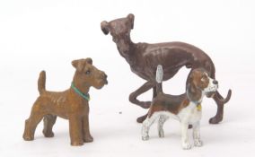 Three cold painted bronze models of dogs, including a whippet, terrier and hound, tallest 7cms (3)