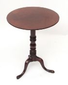 Early 19th century mahogany pedestal table, circular top raised on a ring turned support terminating