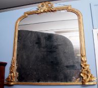 A 19th century giltwood overmantel mirror of shaped arched form, the top and both sides with foliate