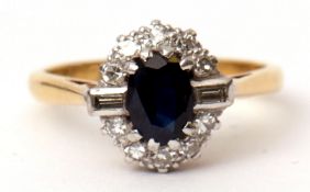 Sapphire and diamond cluster ring, the oval shaped sapphire within a small circular cut diamond