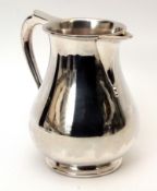 Elizabeth II sparrowbeak type water jug of polished baluster form with applied spout and handle with