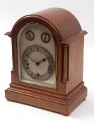 Early 20th century oak cased triple barrel mantel clock, the arched case with overhanging cornice