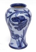 A rare early 20th century Moorcroft baluster vase with tube-lined and painted decoration of lilies