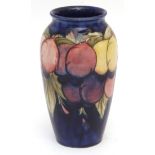 Mid-20th century Moorcroft cylindrical vase decorated with the Wisteria pattern, signature in blue