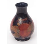 Early 20th century Moorcroft baluster vase decorated with the Pomegranate pattern, 12cms high,