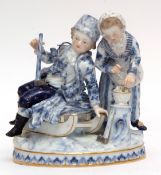 Meissen group of Winter, modelled as two children in blue and white, the boy on a sledge, the girl