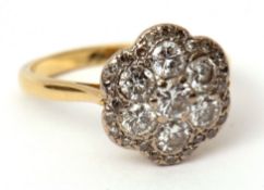 Diamond cluster ring, the circular shaped panel with seven brilliant cut diamonds within a small