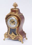 Late 19th century French boule type mantel clock, the waisted case surmounted by a flowering urn