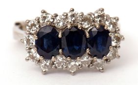 Precious metal sapphire and diamond cluster ring, having three oval shaped sapphires within a