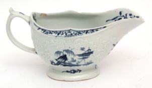 Large Lowestoft sauce boat circa 1765, the body crisply moulded with trailing flowers, bordering a