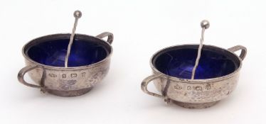 Two George V Arts & Crafts open salts, each of hammered circular form with applied side handles