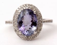 Precious metal tanzanite and diamond ring, the oval cut tanzanite 3.57ct approx, raised within a