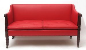 Early 19th century red leather upholstered sofa, scrolled arms raised on spreading fluted supports