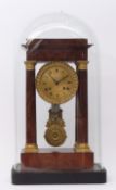 Early 19th century French flame mahogany and gilt brass mounted portico clock, the plinth shaped
