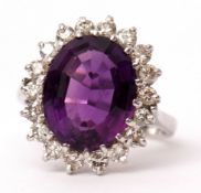 Amethyst and diamond ring, the large oval shaped amethyst (13 x 10mm), claw set and raised within