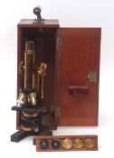Early 20th century mahogany cased black patinated and lacquered brass monocular microscope, W Watson