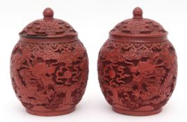 Pair of Chinese cinnabar lacquer jars and covers with deep relief carving of confronting dragons