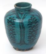 Turquoise glazed pottery vase possibly Persian, with panels of stylised foliage within arched