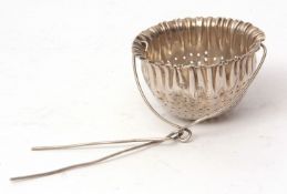 Early 20th century American tea strainer, modelled as a circular fabric bag with pierced body and