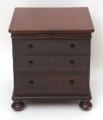 19th century mahogany small chest, brushing slide over three drawers on compressed bun feet, 57cms