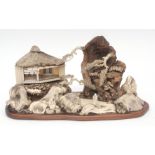 Intricate Japanese diorama depicting a mountainous landscape with pavilions and figures in wood,