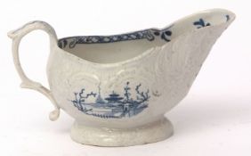 Liverpool (Christmas) sauce boat, circa 1770, the body moulded with trailing flowers bordering two