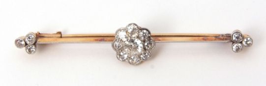 Precious metal diamond cluster bar brooch, the centre flowerhead design set with nine brilliant