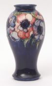 Mid-20th century Moorcroft baluster vase decorated with anemones on a dark blue ground, signature