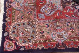 Caucasian style carpet, central floral lozenge and the gull border decorated with panels of urns and