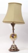 Mid-20th century table lamp and shade with silver metal mounts, the centre with a circular Moorcroft