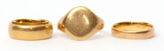 Group of three rings: 18ct gold plain polished signet ring, 7.1gms, together with two 22ct gold