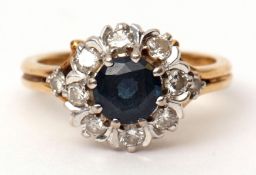 Sapphire and diamond cluster ring, the circular shaped sapphire within a surround of eight small