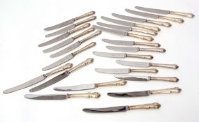 Twelve each Elizabeth II dinner and side knives, Dubarry, each with hollow cast and applied