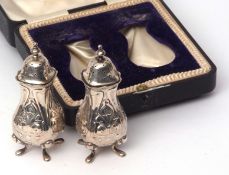 Cased pair of Edward VII pepper casters, each of typical baluster form with Art Nouveau decoration