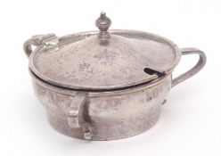 George V Arts & Crafts spot hammered lidded mustard of circular form with three scrolled handles