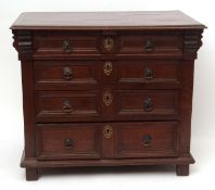 Carolean oak chest, cross-banded top over four graduated moulded drawers on plain stile feet,