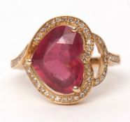 Precious metal spinel and diamond ring, the heart cut spinel 4.2ct approx, surrounded by small