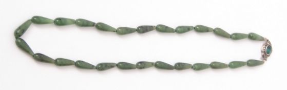 Vintage jade necklace, a single row of torpedo shaped beads to a white metal paste set clasp,