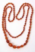 Vintage opera length amber bead necklace, a single row of burnt orange graduated faceted beads, 10mm