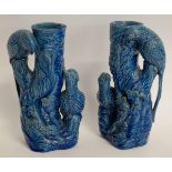Pair of 19th century blue glazed stoneware vases surmounted by parakeets, no maker's mark, 24cms