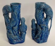 Pair of 19th century blue glazed stoneware vases surmounted by parakeets, no maker's mark, 24cms