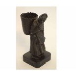 Bronze of an old lady carrying a wickerwork basket on her back on square base, 18cms high